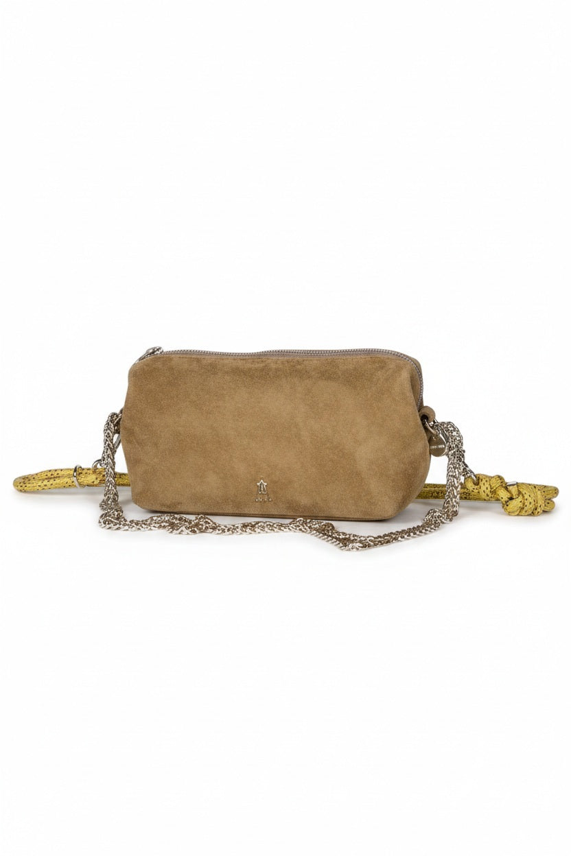 The CRAIE STUDIO - NUAGE SUEDE SEPIA MINI BAG, a compact brown suede shoulder bag featuring a zipper and a long yellow strap, is showcased on a white pedestal against a light background.