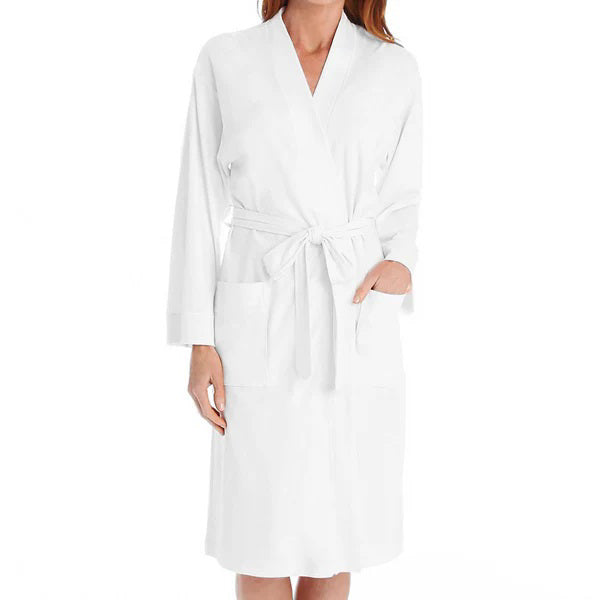 A person wearing the P. JAMAS - BUTTERKNIT SHORT ROBE by FASHIONVIEWS, made of silky light blue fabric with a tied belt. The robe features long sleeves, two pockets near the waist, and a design reminiscent of a kimono style. The individual is standing against a plain white background, with their head not visible.