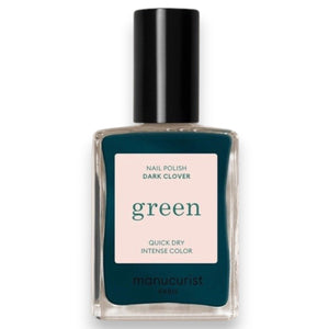 A hand with dark green painted nails rests on silver fabric, next to a matching bottle of MANUCURIST - GREEN™ Nail Polish in Dark Clover by MANUCURIST INC.