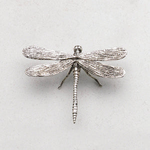 The ZODAX ANTIQUE PEWTER DRAGONFLY features detailed wings and body, shown on a light gray textured background, and fits perfectly in a compact container or small storage box like a 4.75-inch box.