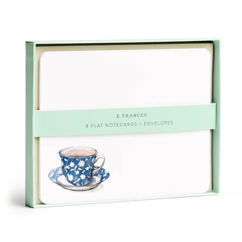 A set of 8 watercolor notecards with envelopes, presented in a light green box. Each card features a blue floral-patterned teacup on a saucer. The band around the box reads "E. FRANCES PAPER - SPOT OF TEA FLAT NOTES.