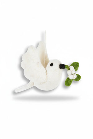 A MISTLETOE DOVE ORNAMENT by FELT SO GOOD hangs on a tree, the felt dove holding a sprig of mistletoe in its beak.