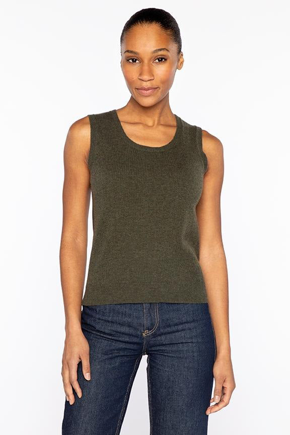 A woman wears the KINROSS CASHMERE - SCOOPNECK TANK IN CASHMERE by KINROSS, sleeveless and dark green, paired with dark blue jeans, as she stands facing forward against a white background with a slight smile.