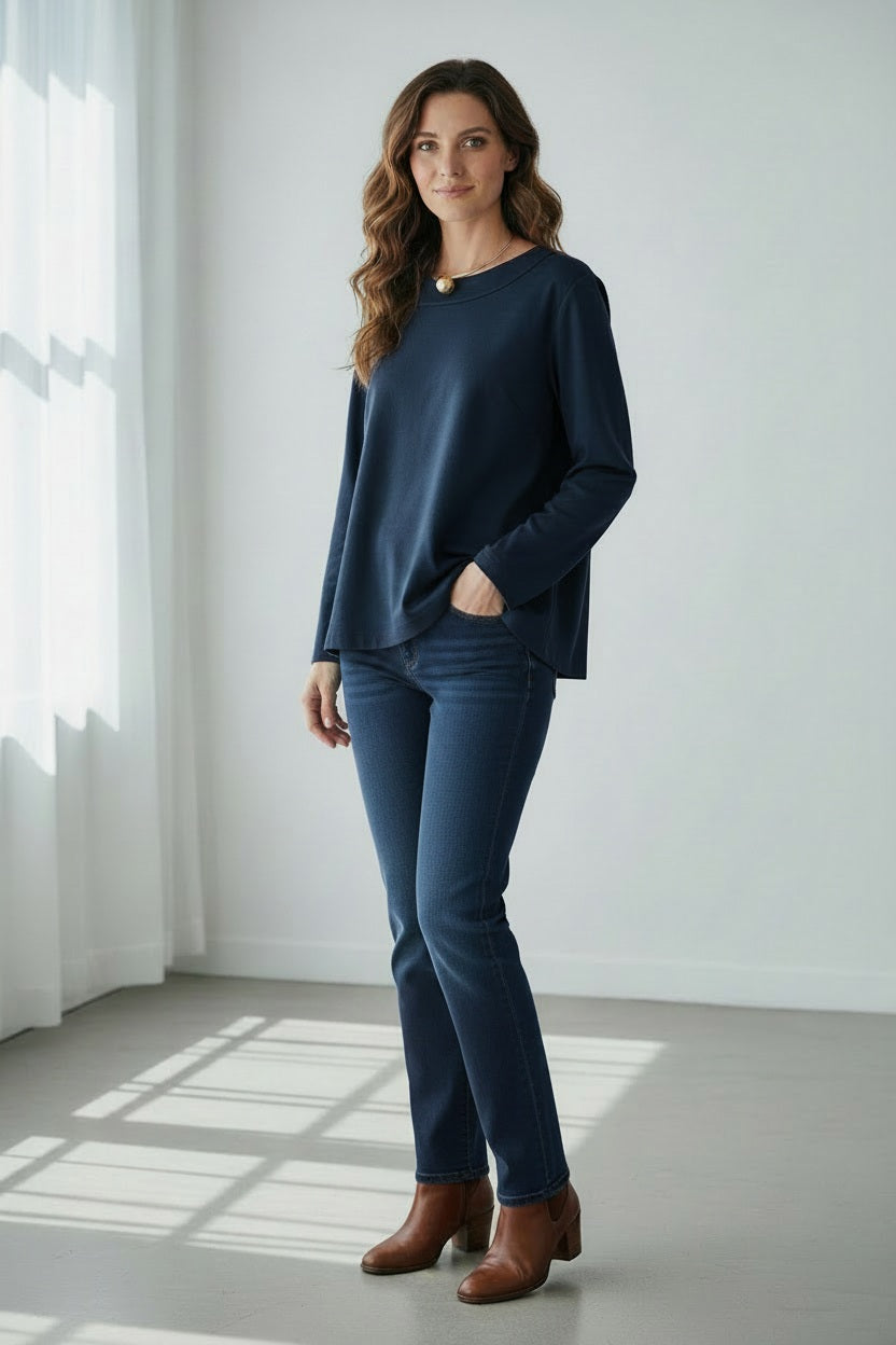 A woman with straight dark hair wears the MEIMEIJ Long Sleeve Ponte Swing Top in teal and a gold pendant necklace, standing against a plain light background, facing forward with a neutral expression.