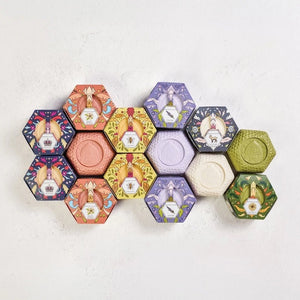 Experience the luxurious BAUDELAIRE - LAVENDER HONEY SOAP 3.5 OZ, HEX BOX—a triple-milled bar delicately scented with lavender. Presented in a hexagonal purple box adorned with elegant floral designs and a central lavender flower illustration, this nourishing soap from BAUDELAIRE offers a gentle and soothing cleanse.