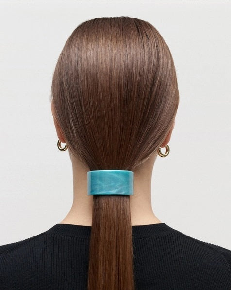 A sleek French Pony Barrette in Alabaster by MACHETE, featuring a marbled cream and light tan pattern, expertly crafted from luxurious Italian acetate and displayed against a plain white background.