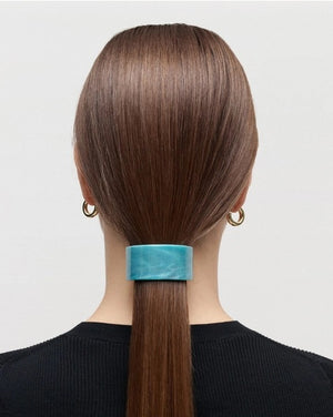 A sleek French Pony Barrette in Alabaster by MACHETE, featuring a marbled cream and light tan pattern, expertly crafted from luxurious Italian acetate and displayed against a plain white background.