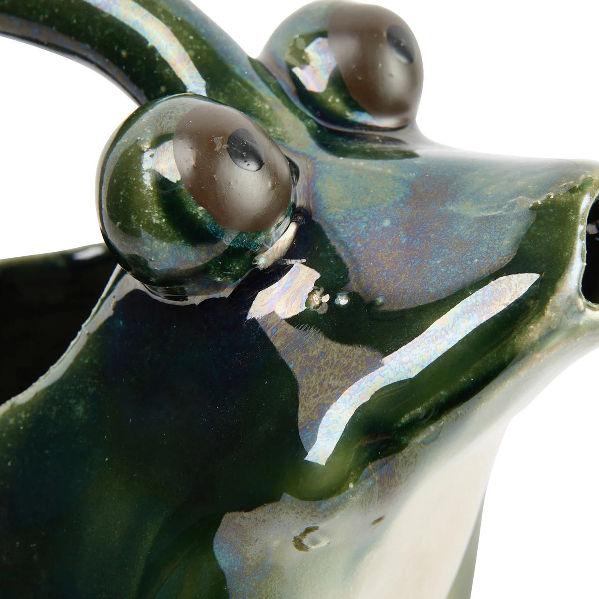 The CREATIVE COOP STONEWARE FROG WATERING PITCHER features a glossy dark green frog shape with brown-accented feet, an arched handle over its back, and a spout at the mouth—ideal as a decorative plant pitcher.