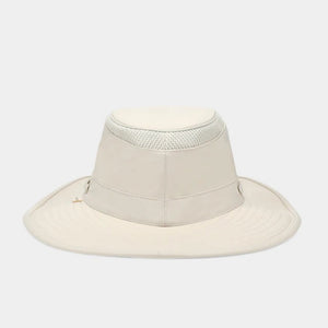 The TILLEY AIRFLO BROAD BRIM HAT LTM6 in Light Stone is a recycled nylon sun hat with UPF 50+ protection, wide brim, mesh ventilation near the crown, and a small band tag. Shown on a plain white background.