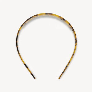 The MACHETE Ultralight Thin Headband in Tortoise features glossy Italian acetate in brown and yellow tones; it's lightweight, curved, fits all hair types, and is shown on a plain white background.