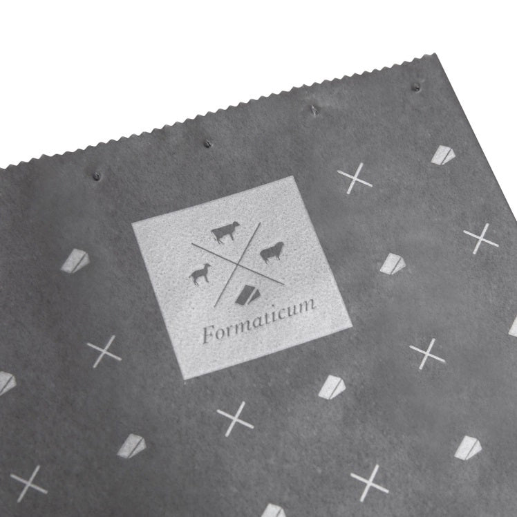 A box of FORMATICUM - REUSABLE CHEESE STORAGE BAGS by FORMATICUM features a white and black design, “Reduce cheese waste” and “Keeps cheese fresher, longer” text, and contains 10 reusable bags.
