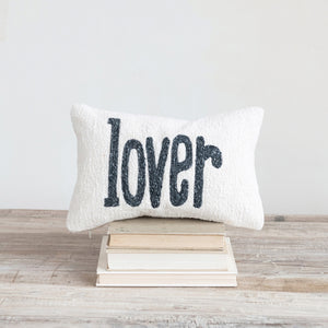 The “LOVER” LUMBAR PILLOW by CREATIVE COOP is a cream-colored cotton slub accent pillow with “lover” in bold black lowercase letters, perfect as a charming decorative piece.