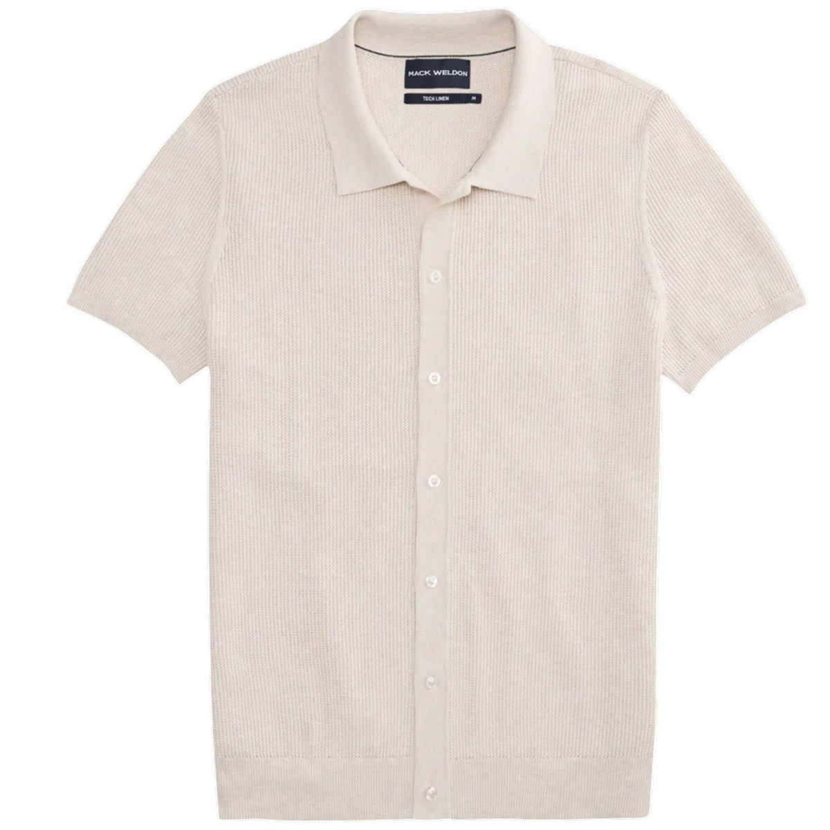 A man with dark hair and a short beard models the MACK WELDON Tech Linen Button Up Sweater Polo in Latte Heather, standing hands-in-pockets against a white background and looking effortlessly stylish and comfortable.
