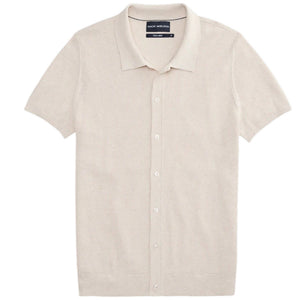 A man with dark hair and a short beard models the MACK WELDON Tech Linen Button Up Sweater Polo in Latte Heather, standing hands-in-pockets against a white background and looking effortlessly stylish and comfortable.