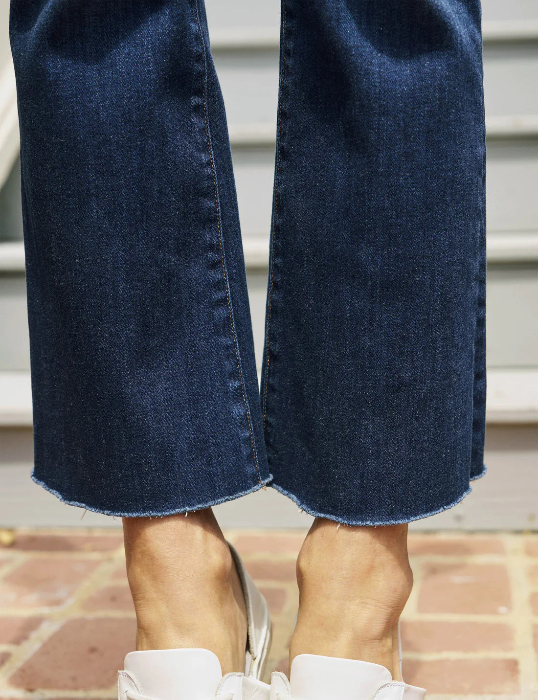A pair of FRANK &amp; EILEEN - Killian Crop Flare Jeans is displayed flat against a textured white background. Made from soft denim with power stretch, they feature a classic five-pocket design, belt loops, and a button and zip closure. The high-rise legs are slightly flared, offering a clean, modern appearance.