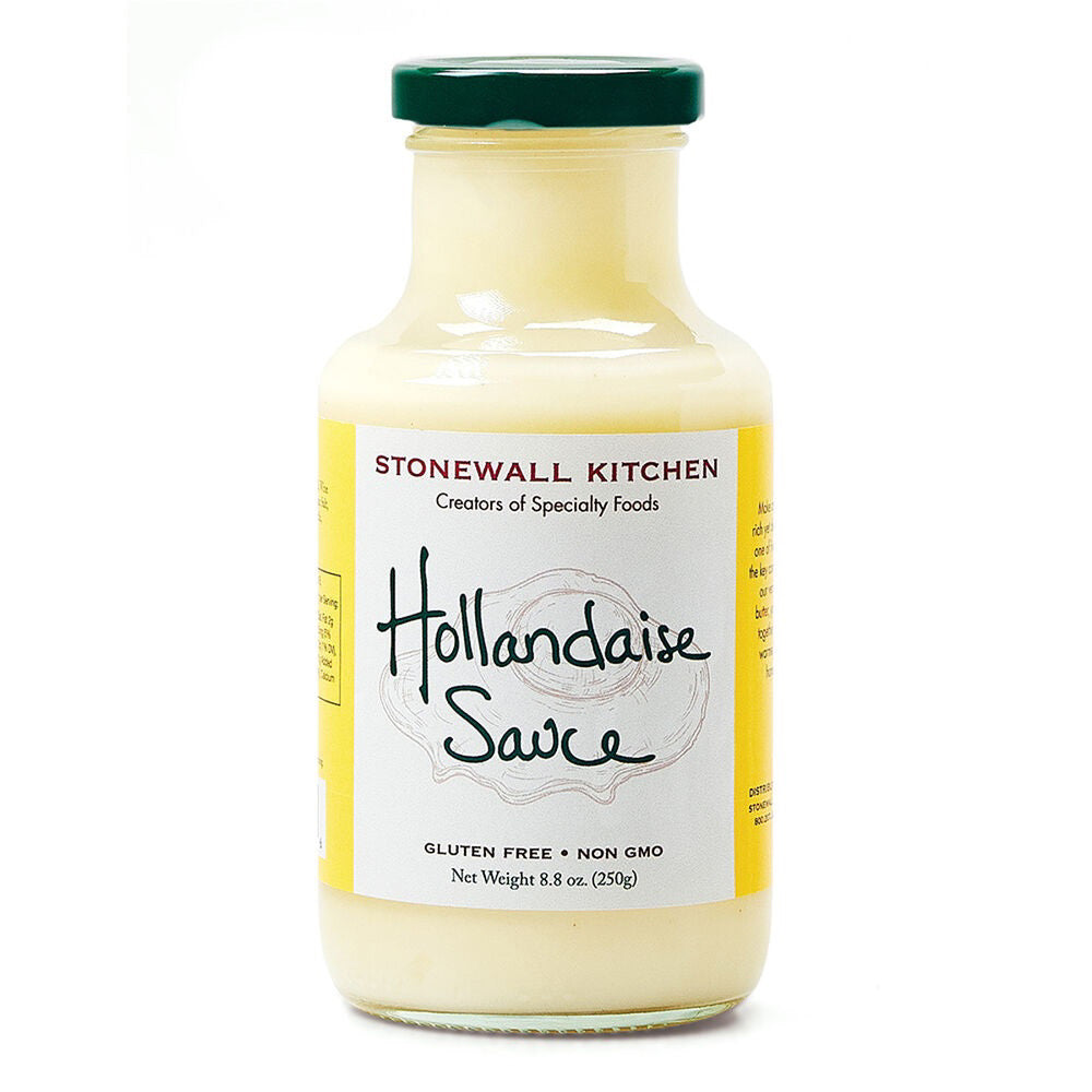 A jar of STONEWALL KITCHEN's classic Hollandaise Sauce with a white cap. The label, in black handwritten font, proudly highlights attributes such as "Gluten Free" and "Non GMO." Ideal for eggs Benedict or adding a touch of elegance from the French mother sauces, the jar contains 8.8 oz (250g) of this delightful sauce.