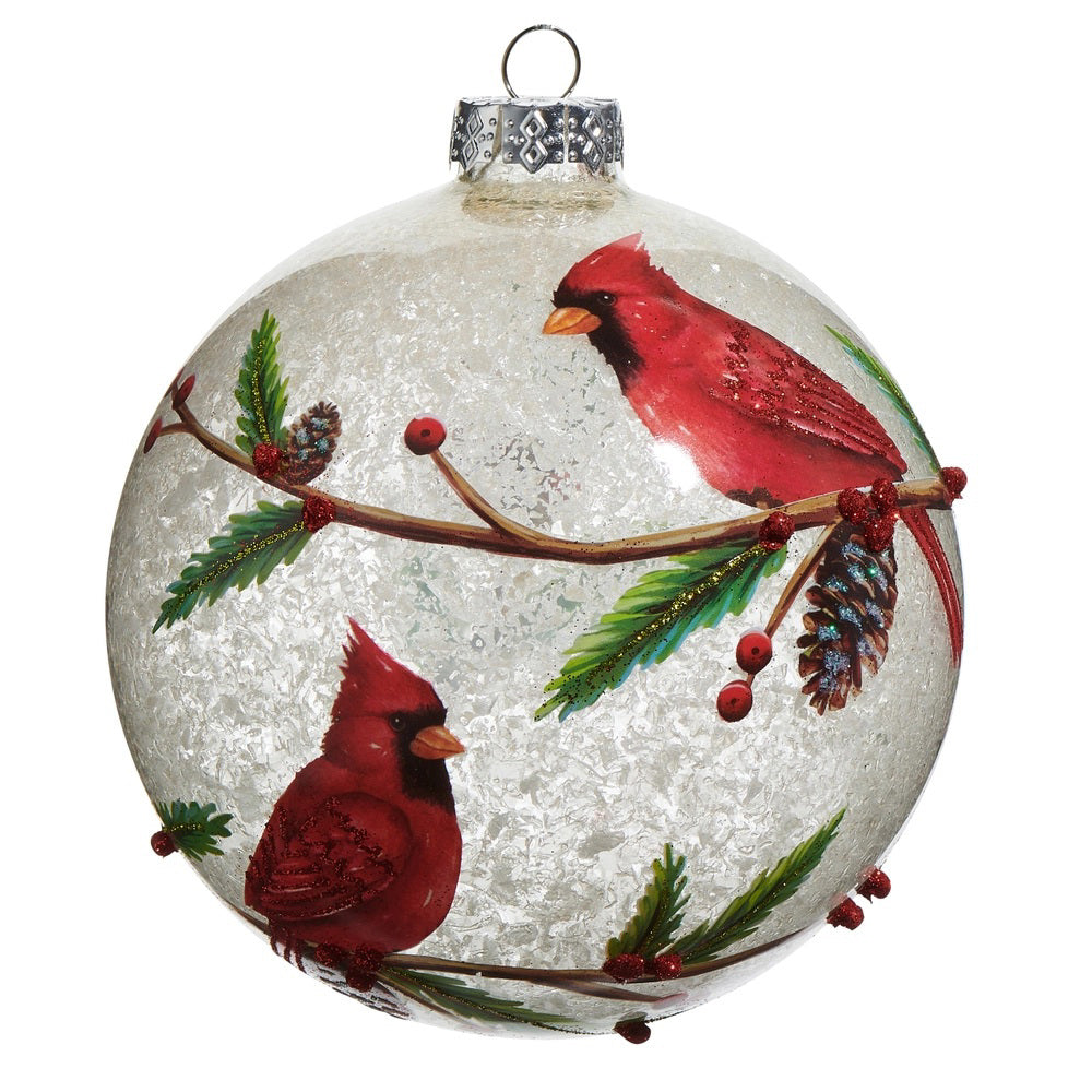 The CARDINAL BALL ORNAMENT by RAZ IMPORTS is a clear Christmas ornament styled like frosted glass, hand-painted with two red cardinals on leafy branches, red berries, and a pine cone in vibrant colors.