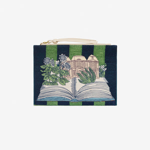 The INOUI EDITIONS - PARIS 7TH ARRONDISSMENT POUCH by INOUI is a rectangular Italian leather pouch with green and navy stripes, an illustrated open book with flowers and a building, plus a white zipper and wrist strap.
