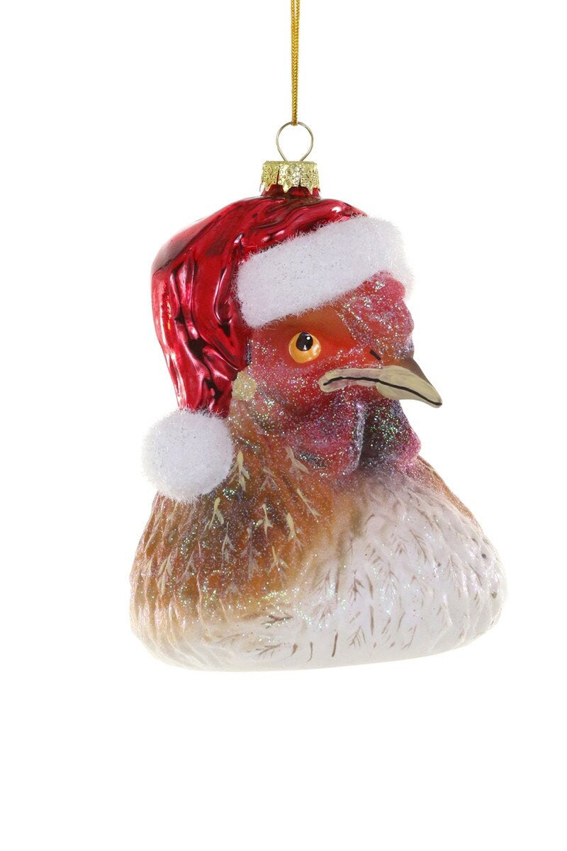 The CODY FOSTER CHICKEN CLAUS ORNAMENT is a 4-inch Christmas tree decoration shaped like a chicken&#39;s head, featuring a red and white Santa hat and a gold hanging loop at the top.