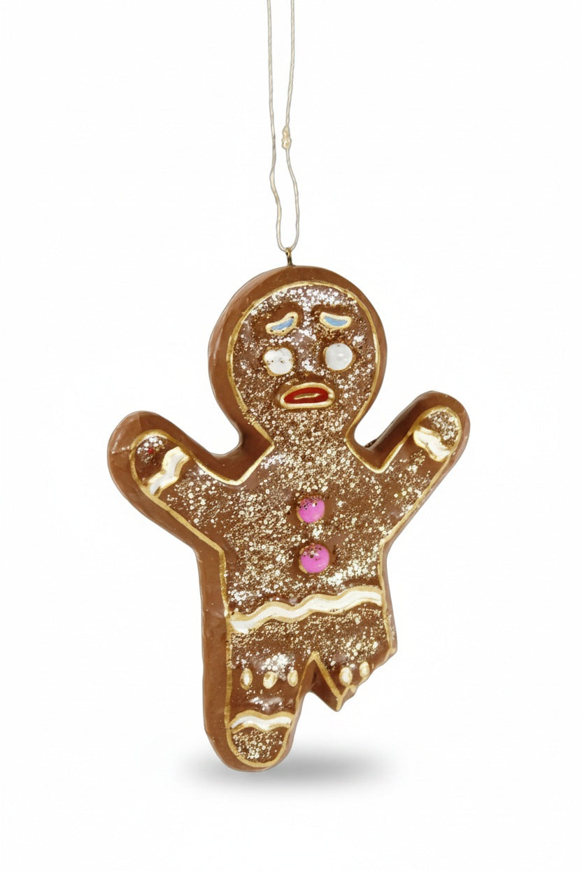 A 4.5-inch Cody Foster GINGERBREADMAN ORNAMENT featuring a resin gingerbread man with a worried expression, two pink buttons, and white icing accents.