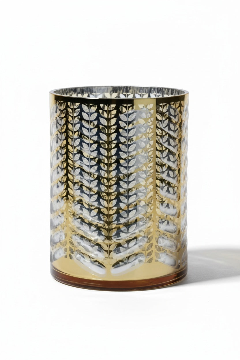 Three 7 in x 9.5 in ZODAX LASER ETCHED METALLIC HURRICANE 19.5″ cylindrical glass hurricane candle holders with laser-etched metallic leaf patterns.