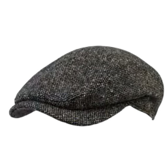A close-up of the WIGENS Ivy Contemporary Donegal Tweed Cap in Dark Green highlights its authentic Donegal Tweed texture, featuring tiny flecks of red, yellow, blue, and purple woven throughout a richly mottled dark green background.