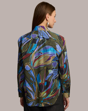 A woman with long brown hair wears the HINSON WU Halsey Long Sleeve Shirt in Abstract Print, made from a premium cotton blend, posing against a plain background with a neutral expression.