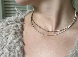 The ANN LIGHTFOOT - Mookite Ombre Ras du Cou Necklace features small, round brown and pink beads with a sterling silver clasp, shown in a circular shape on a white background.