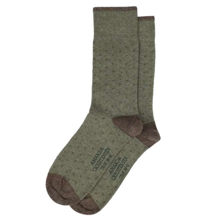 Crafted in Italy from a premium combed cotton blend, the AMANDA CHRISTENSEN True Dot Mid-Calf Socks in Olive Melange feature an elegant small dot pattern with contrasting brown heels, toes, and cuffs. Laid flat on a white background, these socks display printed text on the soles.