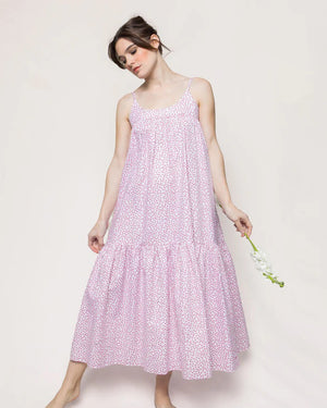 Introducing the PETITE PLUME - SWEETHEARTS CHLOE NIGHTGOWN, a luxurious sleeveless, ankle-length dress with thin straps and a soft, flowing silhouette. Crafted from the finest quality cotton, it boasts a delicate pink floral print on a white background and is gathered at the waist to create a tiered effect on the skirt—evoking an air of exquisite elegance reminiscent of luxury sleepwear.