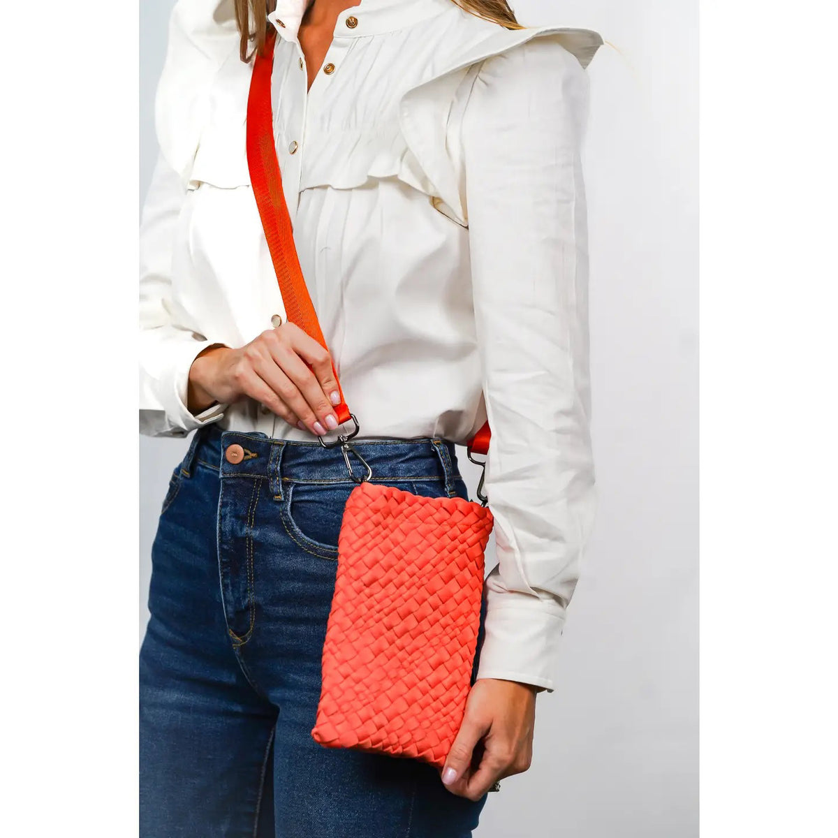 Close-up of the PARKER AND HYDE Mini Woven Messenger from PARKER &amp; HYDE, showcasing black, silver, and gold strips. It features a crossbody strap with a silver buckle, ideal for on-the-go style and convenience.