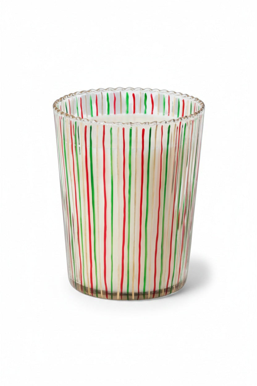 Ribbed, striped ALPINE STILL SCENTED CANDLE 6″ and ornaments arranged on a silver tray placed on a book titled The Christmas Book.