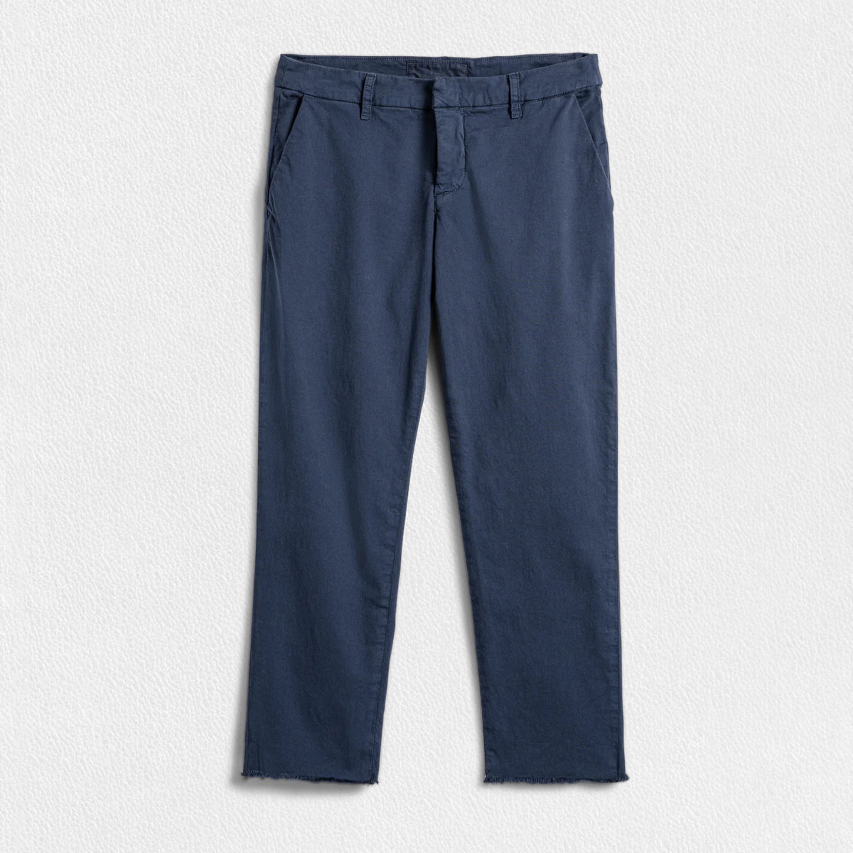 A pair of FRANK &amp; EILEEN’s THE WICKLOW Italian Chinos in Performance Twill, featuring a navy blue color, straight legs, and raw unfinished hems, is laid flat on a light textured background for an Italy-meets-California vibe.