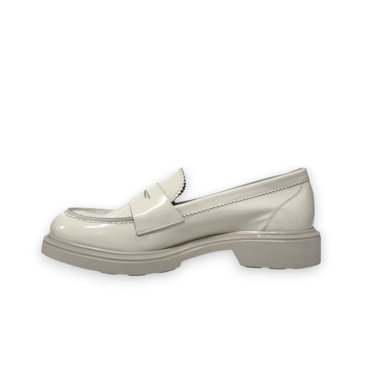 A single ANNA Loafer in Butter by MICHELE LOPRIORE, made with beige patent leather and featuring a chunky rubber sole, is displayed against a white background. This classic shoe showcases subtle stitched details and boasts a 3 cm height for added style.