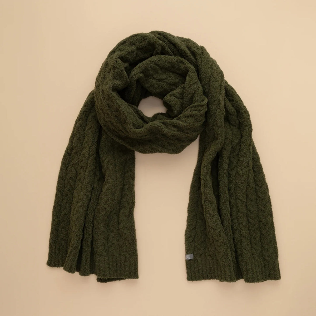 A dark navy blue SOFTIES - CABLE KNIT MARSHMALLOW SCARF draped in a loop.