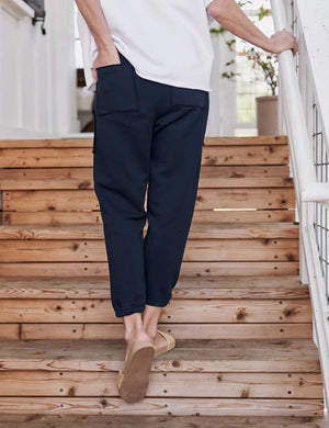 The FRANK & EILEEN Eamon Jogger Sweatpant in British Royal Navy features a stylish drawstring waistband, noticeable stitching on the two sizable front pockets, and fitted cuffs at the ankles. Constructed from 100% cotton, these sweatpants offer a soft and comfortable fabric that is perfect for both casual and athletic wear.
