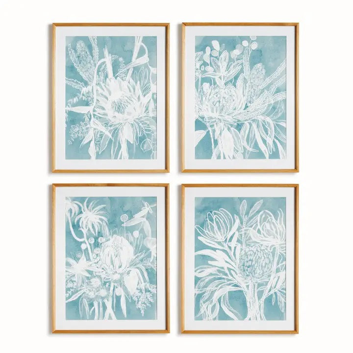 A framed protea abstract print in soft blue by NAPA HOME AND GARDEN, featuring a white floral illustration on a blue background. This botanical wall art is presented in a light wood frame for a fresh, contemporary look—perfect for modern home décor.