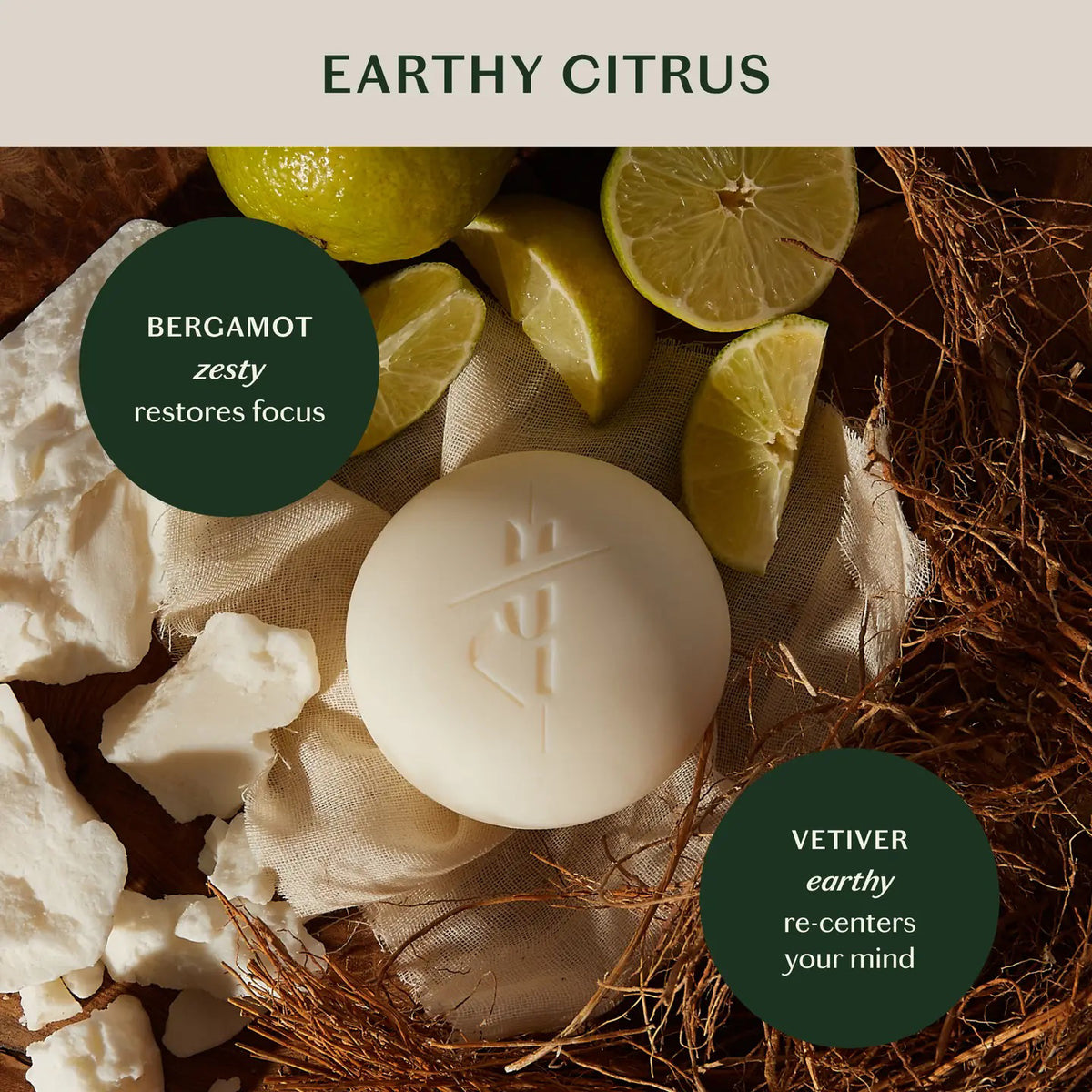 A round white KATE MCLEOD Grounding Stone deep moisturizing lotion bar sits on textured fabric next to an open container with a wooden lid, featuring a dark green label with orange and white text, highlighting its luxurious blend of cocoa butter concentrate and natural essential oils.