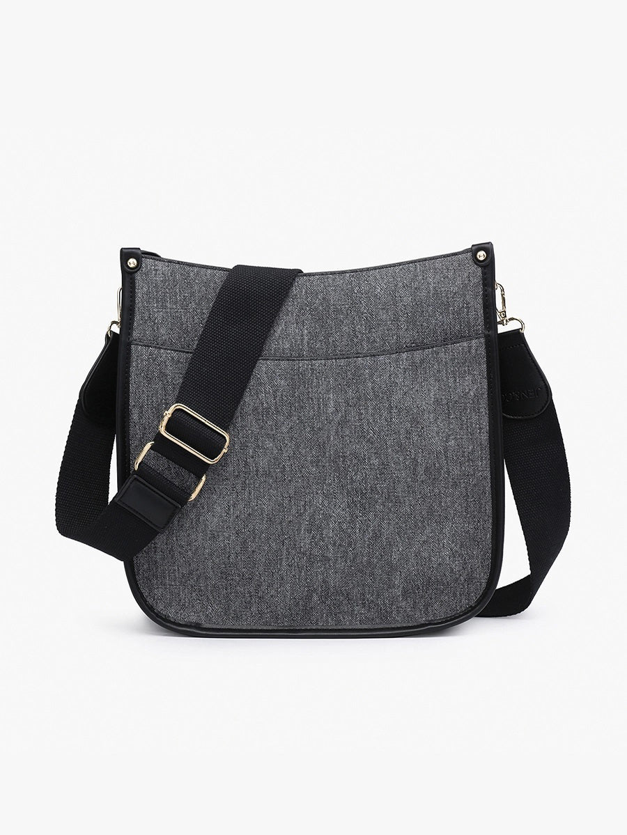 The JEN &amp; CO DENIM CROSSBODY WITH GUITAR STRAP showcases a trendy gray fabric, black trim, adjustable guitar strap, and stylish rectangular shape with rounded corners. It features a front pocket and is set against a plain white background for both style and functionality.