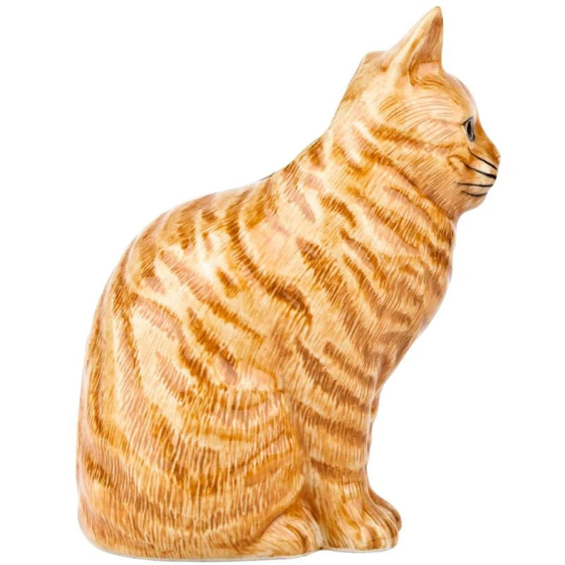 The QUAIL DESIGNS QUAIL CERAMICS - VINCENT FLOWER VASE, shaped like an orange tabby cat, holds a bouquet of bright yellow flowers and green leaves.