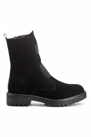 The REQINS - DUSKY SUEDE ANKLE BOOT IN NOIR features black suede leather, chunky cleated rubber soles, elastic panels on the front, and side zippers, and is displayed on a light background.