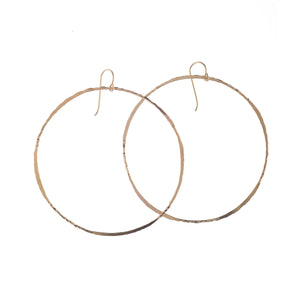 KENDA KIST - BETSY HOOPS: Large, hand-forged 14k gold filled hoops by KENDA KIST featuring simple hook clasps, shown on a plain white background.