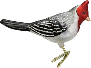 RED CRESTED CARDINAL CLIP ORNAMENT by Old World Christmas, featuring a glass bird with a bright red head and crest, black-and-white feathered wings, and a clip base, perched on a pine branch.