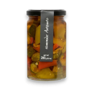 A glass jar with a black lid contains Ritrovo's Cascina Rossa - Antipasto della Casa - Sweet & Savory. The jar displays a black label with white text reading "Cascina Rossa - Antipasto della Casa - Sweet & Savory" and indicates a net weight of 280 grams (9.9 oz). The contents include an assortment of Italian antipasto vegetables.