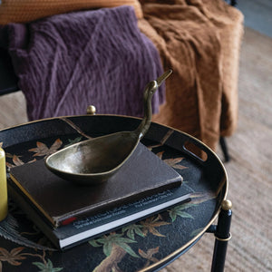 The CREATIVE COOP BIRD SHAPED BOWL IN ANTIQUE BRASS FINISH features a cast aluminum body with an elongated neck and beak, resembling a crane or heron for a stunning decorative accent.