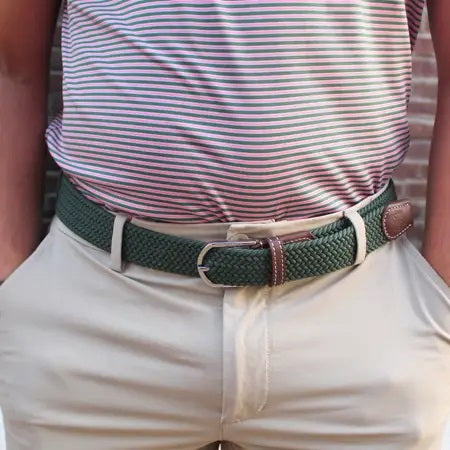 The ROOSTAS SIERRA Woven Stretch Belt features dark green braiding, brown leather accents with white stitching, a silver adjustable clasp, and an embossed rooster logo for a refined touch.