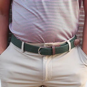 The ROOSTAS SIERRA Woven Stretch Belt features dark green braiding, brown leather accents with white stitching, a silver adjustable clasp, and an embossed rooster logo for a refined touch.