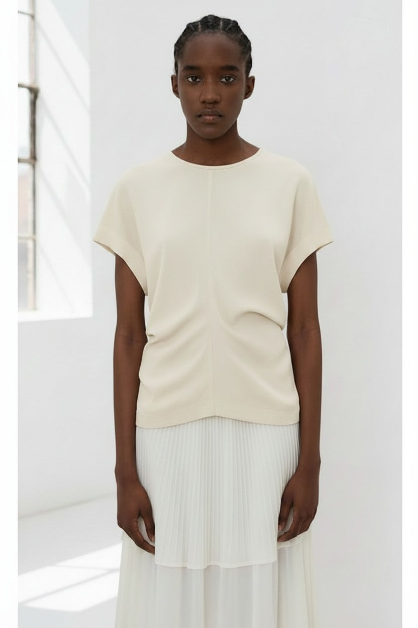The image portrays a solid black square with a textured, slightly uneven surface. With subtle shading variations, it seems to be a photograph perfectly capturing the minimalist essence of the MEIMEIJ - CAP SLEEVE TOP from the MEIMEIJ brand.