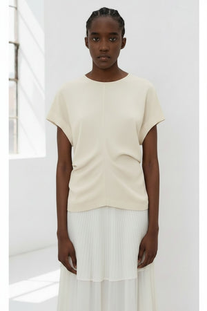 The image portrays a solid black square with a textured, slightly uneven surface. With subtle shading variations, it seems to be a photograph perfectly capturing the minimalist essence of the MEIMEIJ - CAP SLEEVE TOP from the MEIMEIJ brand.