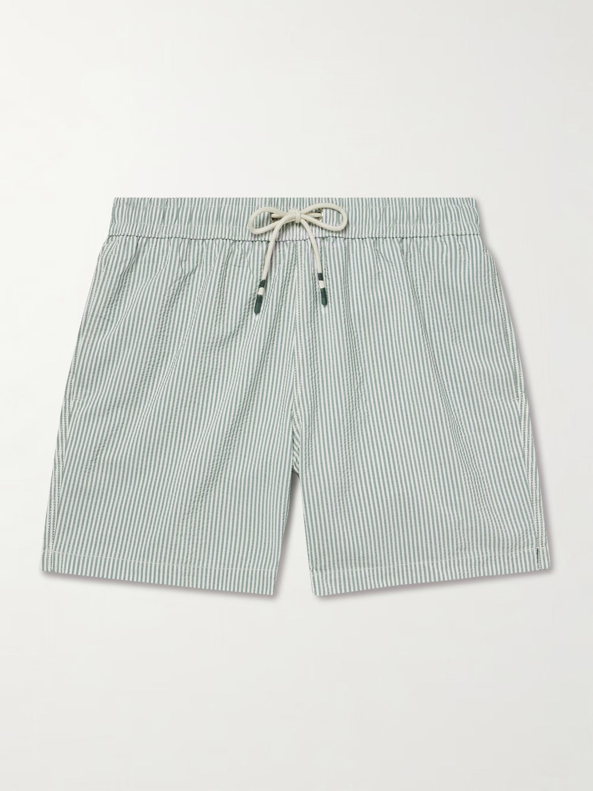 A person wearing HARTFORD - SEERSUCKER SWIM TRUNKS IN GREEN with an elastic waistband and drawstring stands against a plain light background.